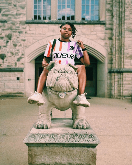 Bria from Soul Culture models Wild NUEVA's World Cup home jersey