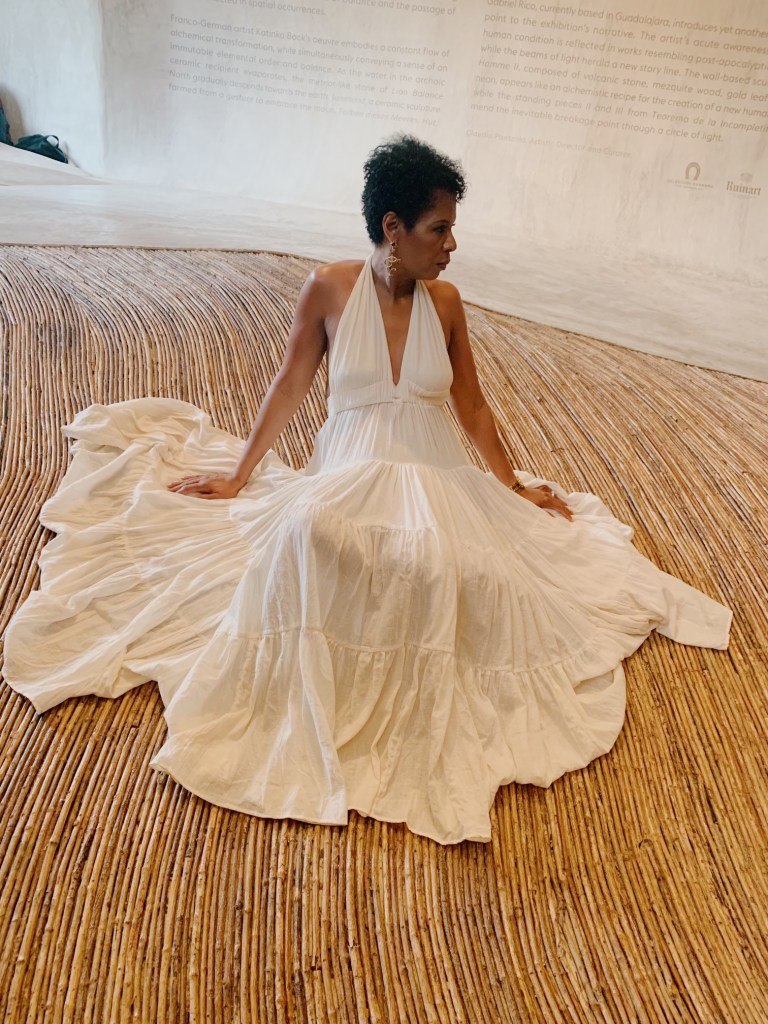 Cydney Paige's mother seated in a white dress.